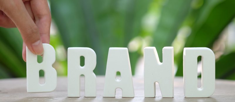 hand-arrange-white-letters-brand